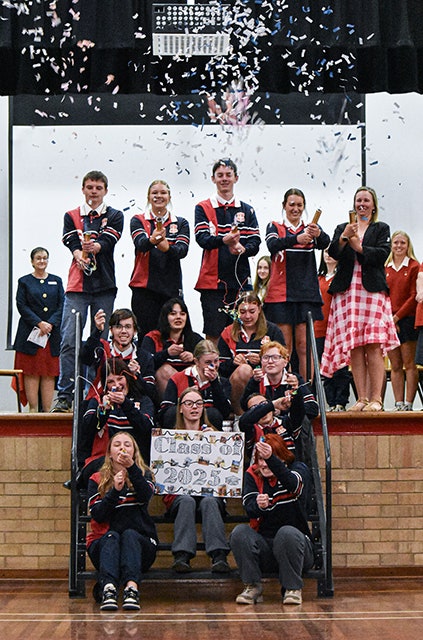 Year 12 celebrating with party poppers at the assembly