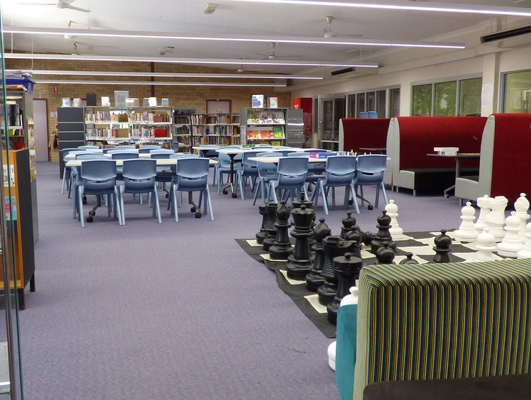 Walcha Central School library with books and giant chess set