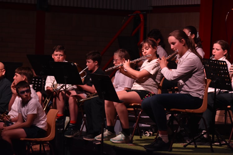 Students performing in band at night performance